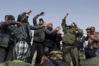 Libyan rebellion supporters perform a song to cheer fighters heading to the frontline from the eastern town of Ajdabiya on April 6, 2011.